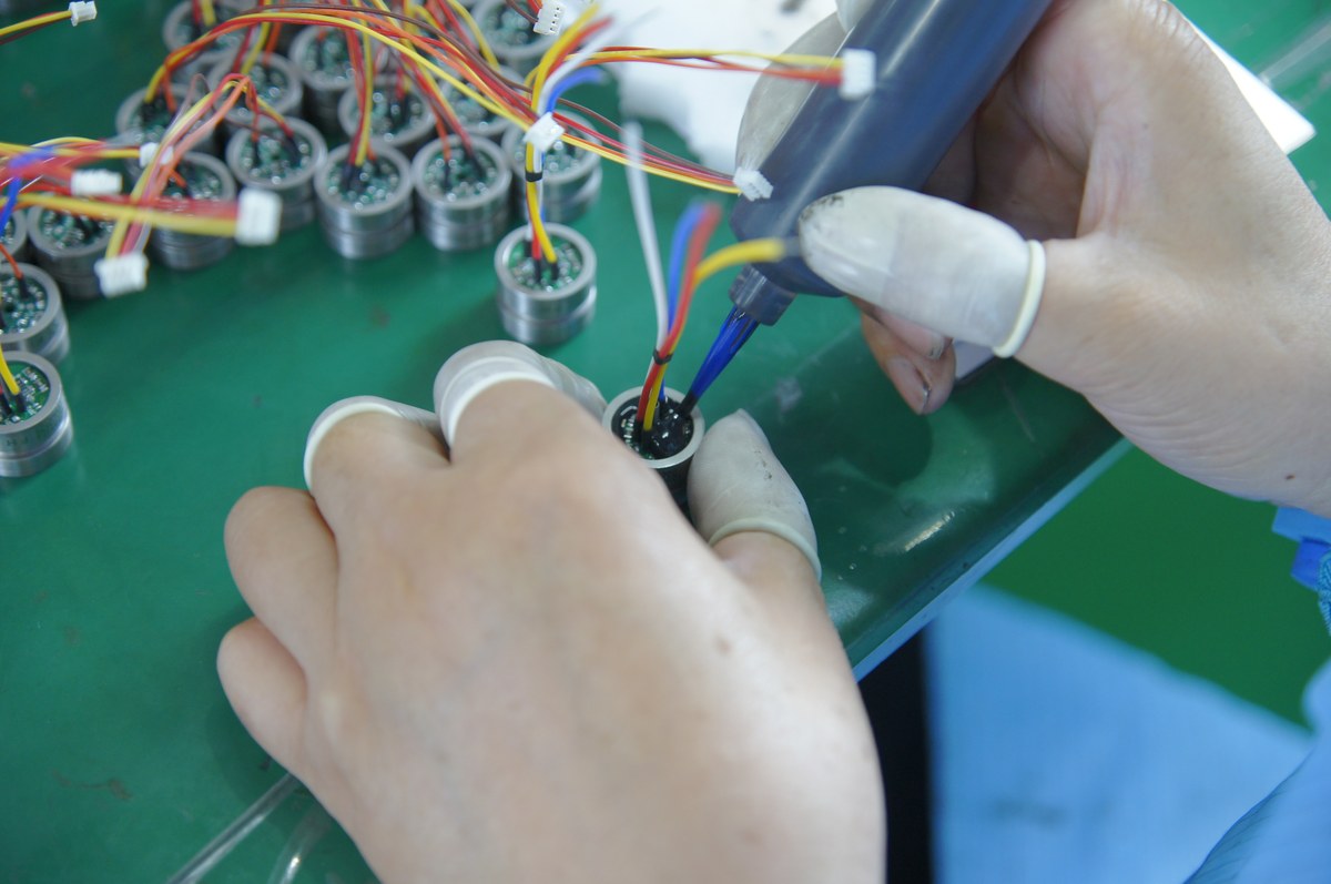 Potting compound applied to a pressure sensor core with its lead wires in place